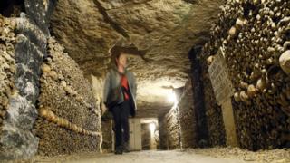 A woman visits the Catacombs of Paris on 14 October 2014