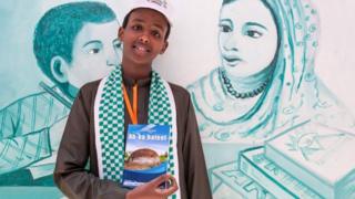 Abdishakur Mohamed, 16, a young author from Somaliland holds up a copy of his book on July 21, 2018 at the Hargeisa International Book Fair in the Somaliland capital of Hargeisa, Somalia.