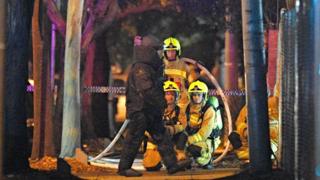 Firefighters and a bomb disposal squad member in Merrylands, Sydney, 21 July
