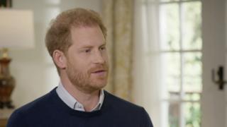 A still of Prince Harry from the interview with ITV's Tom Bradby, the image showing his face and shoulders. He appears to be midway through speaking.