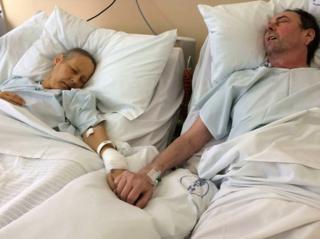 Julie and Mike Bennet in hospital holding hands