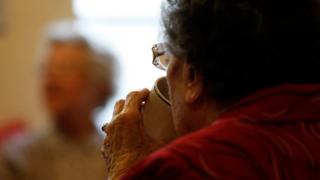 Elderly woman with hot drink