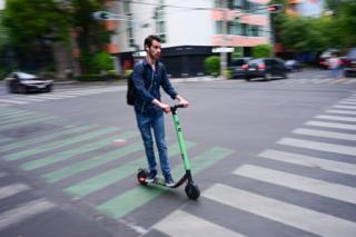 A man riding a scooter in Mexico City