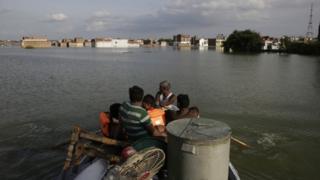 Rescuers shift residents to safer places following floods in the River Ganges in Allahabad, India, Sunday, Aug. 21, 2016.
