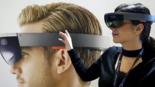 A visitor tries a virtual reality (VR) headset Microsoft HoloLens during the Virtuality Paris 2018 show, 8 February 2018