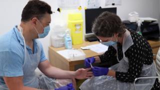 A man gets a rapid antibody finger test for Covid-19