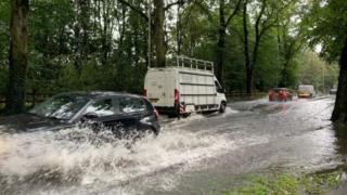 cars navigate localised floods in Leicester