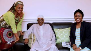 Nigerian President Muhammadu Buhari (C) poses with his wife Aisha Buhari (R) and the wife of Benue State Governor Eunice Ortom as he receives a courtesy visit delegation of Nigeria"s Governor"s Forum led by Chairman Governor Abdulaziz Yari at Abuja House in London.