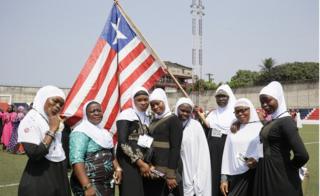 Liberian Muslim women poses with the Liberian flag during observance of World Hijab Day in Monrovia, Liberia, 01 February 2019.