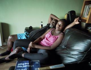 Cameron and Adia relax on the sofa