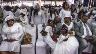 Mourners of preacher Elisabeth Wosho Onyumbe dressed in white at her funeral in Kinshasa, DR Congo - Saturday 23 June 2018