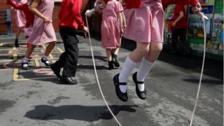 Children play hopscotch and skip rope during playtime