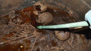  A photo distributed on July 19, 2018 by the Egyptian Ministry of Antiquities showing skeletons in the sarcophagus of black granite discovered in Alexandria, filled with sewage 