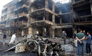 People gather at the site of a suicide car bomb in the Karrada shopping area, in Baghdad, Iraq July 3, 2016
