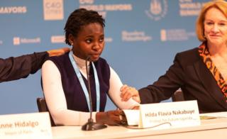Hilda Flavia Nakabuye is comforted by two other attendees as she speak at C40 Copenhagen.