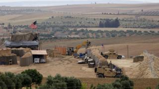 Image shows vehicles and structures of the US-backed coalition forces in the northern Syrian town of Manbij