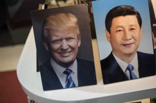 Framed photographs of Chinese President Xi Jinping (R) and US President Donald Trump are seen on display in a photo shop in Beijing on November 6, 2017. Donald Trump arrives in China on November 8, which is the third stop of his tour in Asia. / AFP PHOTO / FRED DUFOURFRED DUFOUR/AFP/Getty Images