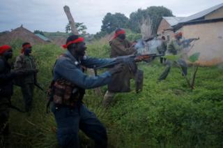 SPLA-IO (SPLA-In Opposition) rebels fire weapons during an assault on government SPLA (Sudan People's Liberation Army) soldiers in the town of Kaya, on the border with Uganda, South Sudan, 26 August 2017.