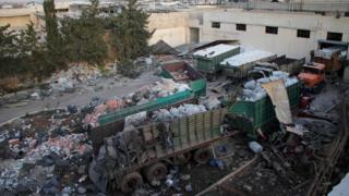 Aid is seen strewn across the floor in the town of Orum al-Kubra on the western outskirts of the northern Syrian city of Aleppo on Septmber 20, 2016, the morning after a convoy delivering aid was hit by a deadly air strike
