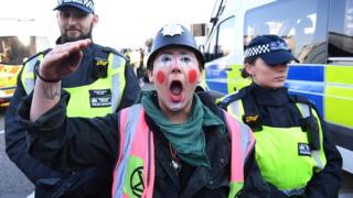 Protester and police officers on Lambeth Bridge