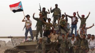 Members of the UAE-backed southern Yemeni separatist forces stand atop a tank during clashes with government forces in Aden on 10 August