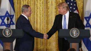 US President Donald Trump (R) and Israel Prime Minister Benjamin Netanyahu (L) shake hands during a joint news conference at the East Room of the White House