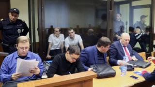 Vyacheslav Kryukov (far left) and Ruslan Kostylenkov (2nd left) in court