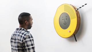 Solo radio on the wall with young man in front of it