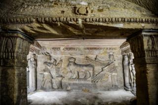 Columns and detailed relief art is seen inside the catacombs of Kom El-Shoqafa (Mound of Shards) under Alexandria, Egypt.