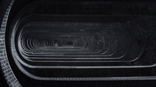A downward view of a brick viaduct