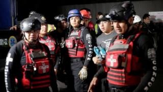Members of a rescue team wait outside a building after a structural collapse in a car park under construction in Mexico City, Mexico April 10, 2017.