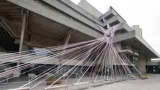 National Theatre wrapped in pink barrier tape