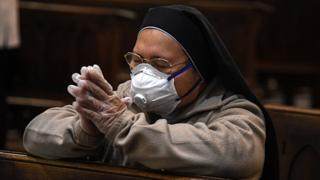A nun wearing protective mask and gloves prays in an empty Duomo (the Naples' cathedral) in the day of the May's Miracle of Saint Gennaro.