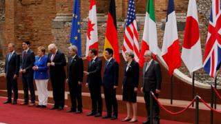 European Council President Donald Tusk, Canadian Prime Minister Justin Trudeau, German Chancellor Angela Merkel, US President Donald Trump, Italian Prime Minister Paolo Gentiloni, French President Emmanuel Macron, Japanese Prime Minister Shinzo Abe, Britain's Prime Minister Theresa May and European Commission President Jean-Claude Juncker pose for a family photo at the Greek Theatre during the G7 Summit in Taormina, Sicily,