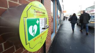 An emergency defibrillator on a wall in the centre of Garforth, Leeds.