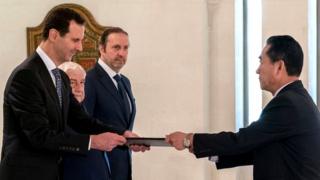President Bashar al-Assad (left) receiving diplomatic credentials from North Korea