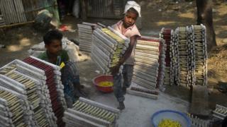 A Bangladeshi child works at balloon factory in Dhaka on October 20, 2014