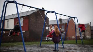 Children playing on swings in a playground