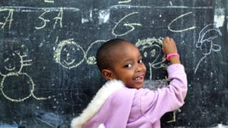 Pikin wey dey write for board