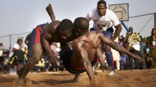 A Malian wrestler brings down his opponent according to the rules of the traditional wrestling during the traditional wrestling festival in Bamako, Mali -Sunday 7 April 2019