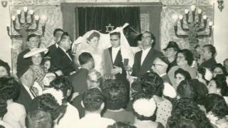 People at a wedding in a synagogue