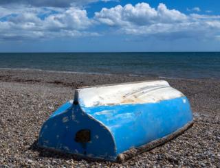 An overturned boat on a beach