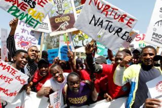 Protesters in Nairobi holding placards