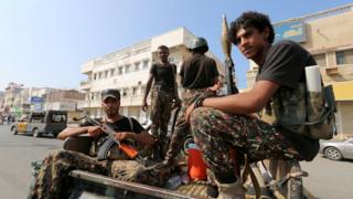 Houthi militants patrol a street in the port city of Hudaydah