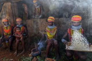 A family sitting and cooking