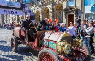 The first car home at the end of the Flying Scotsman car rally on a glorious afternoon on the high street in Edinburgh on Sunday.