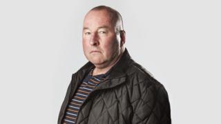 Wrexham Council's Bill Baldwin has been accused of sharing racist material on the internet