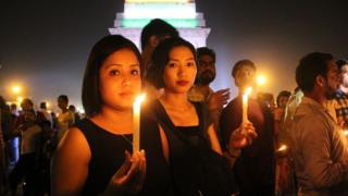  Girls and young people holding candles in solidarity with a rape victim in India 