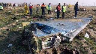 Rescue teams inspect the wreckage of Ukrainian International Airlines flight PS752