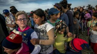 Children queue for food at the makeshift camp for migrants and refugees at the Greek-Macedonian border near the village of Idomeni on April 27, 2016.